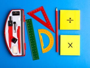 front-view-geometric-figures-with-pencil-stickers-blue-surface